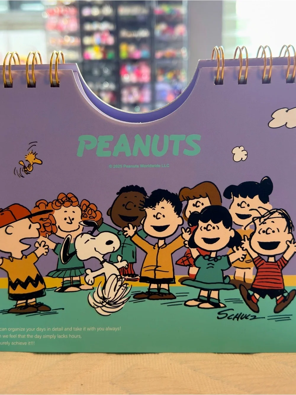 Peanuts Desk Calendar — Purple Cover with Teal Logo